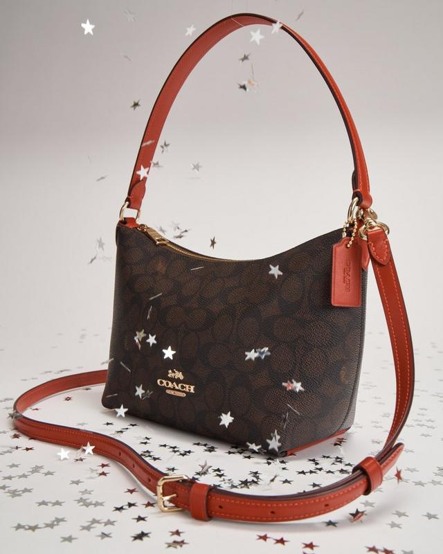 a coach purse with stars on it and a star on the handle