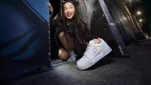 a woman in a black dress kneeling down in a doorway